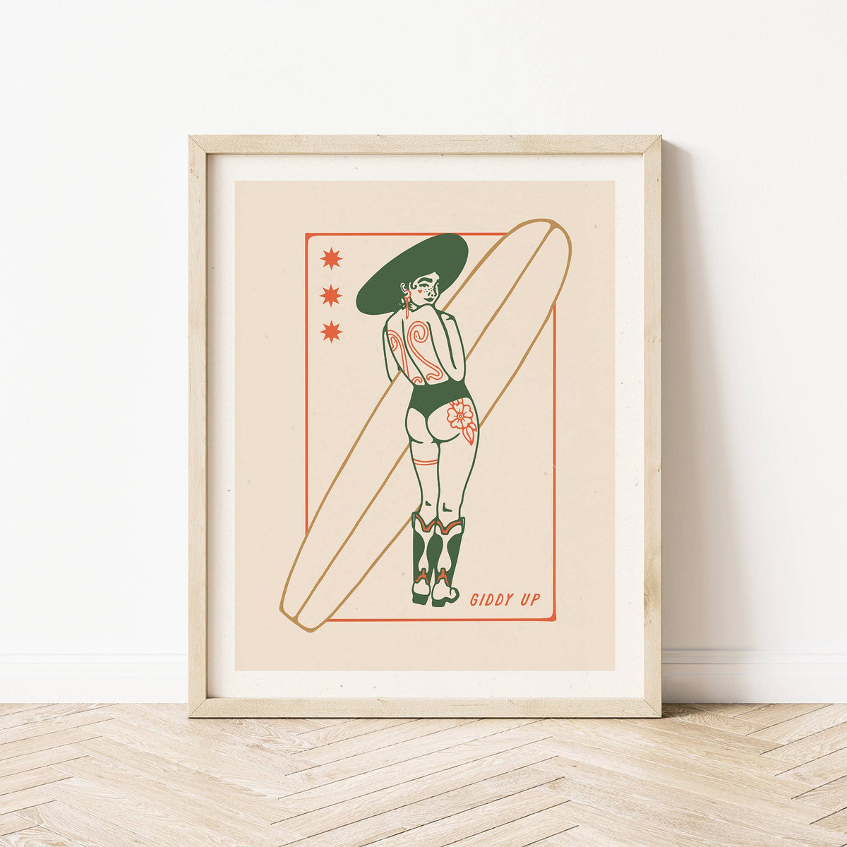Framed artwork of a woman with tattoos holding a surfboard on a beige background