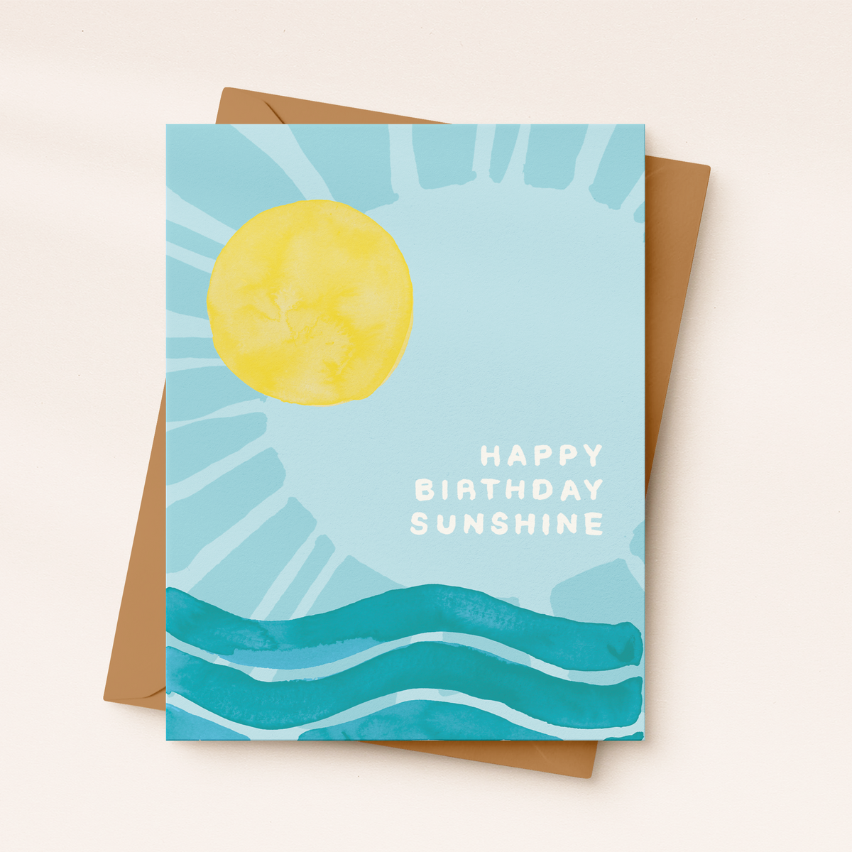 Greeting card with sun and water design and 'Happy Birthday Sunshine' text on a beige background