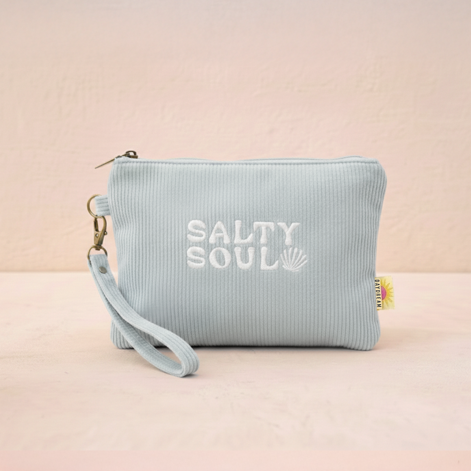 Light blue pouch with 'Salty Soul' text on a beige background