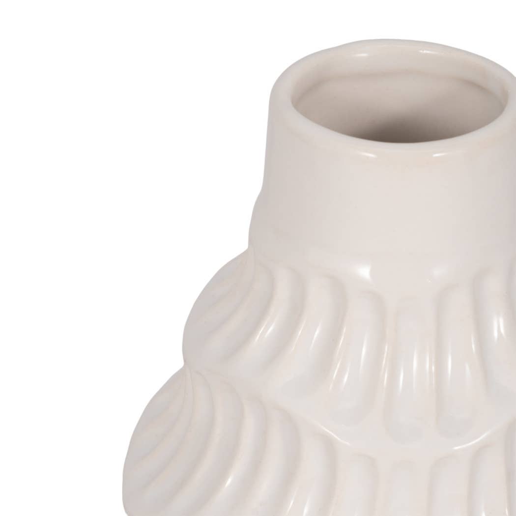 Close-up of a glossy white ceramic vase with a flared rim and vertically ribbed textured body on a white background.