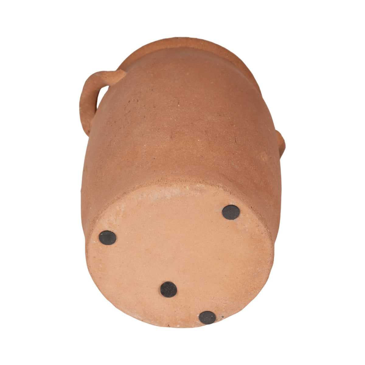 Terracotta-colored cylindrical object with black spots on a white background