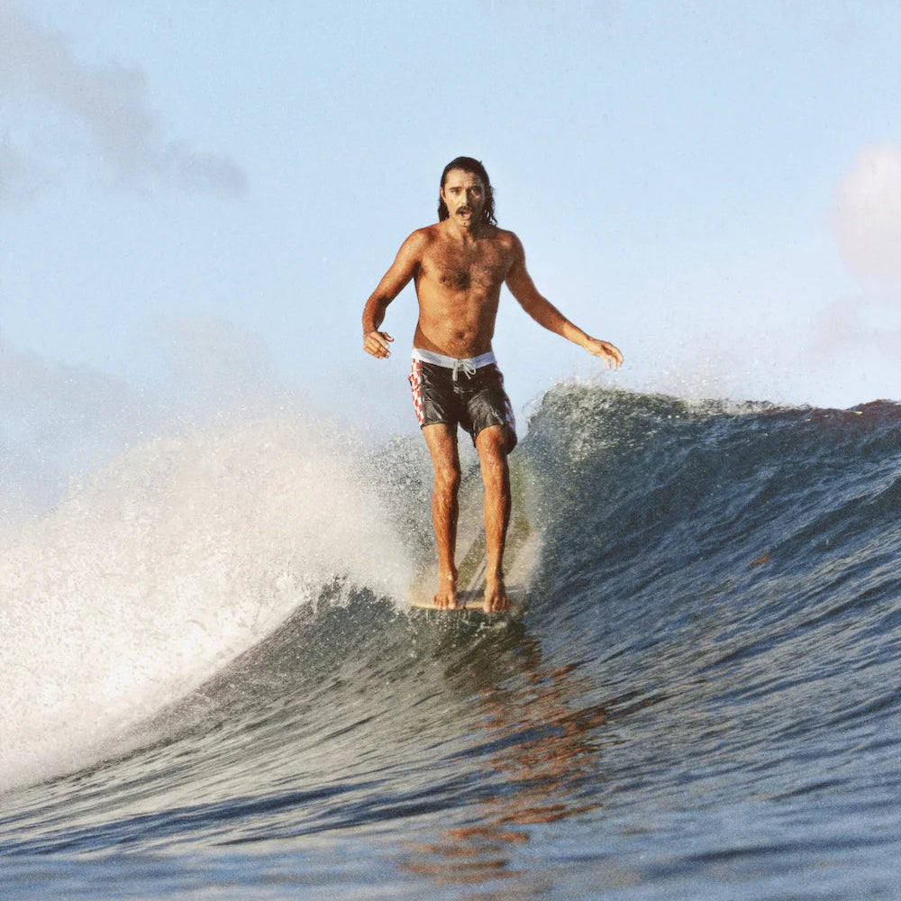 Man surfing an an Almond Surfboard
