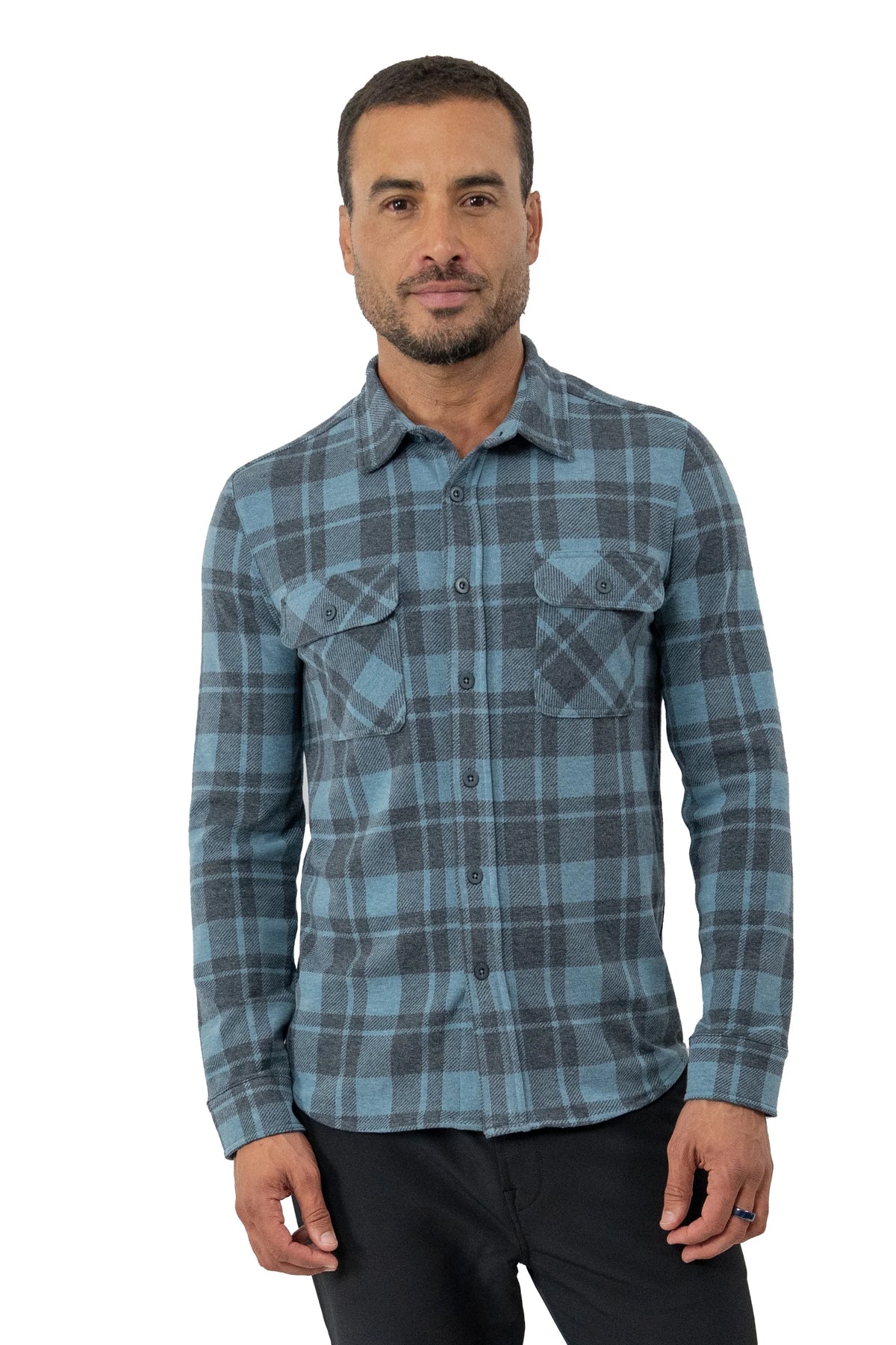 Man wearing blue plaid fleece shirt in front of a white background