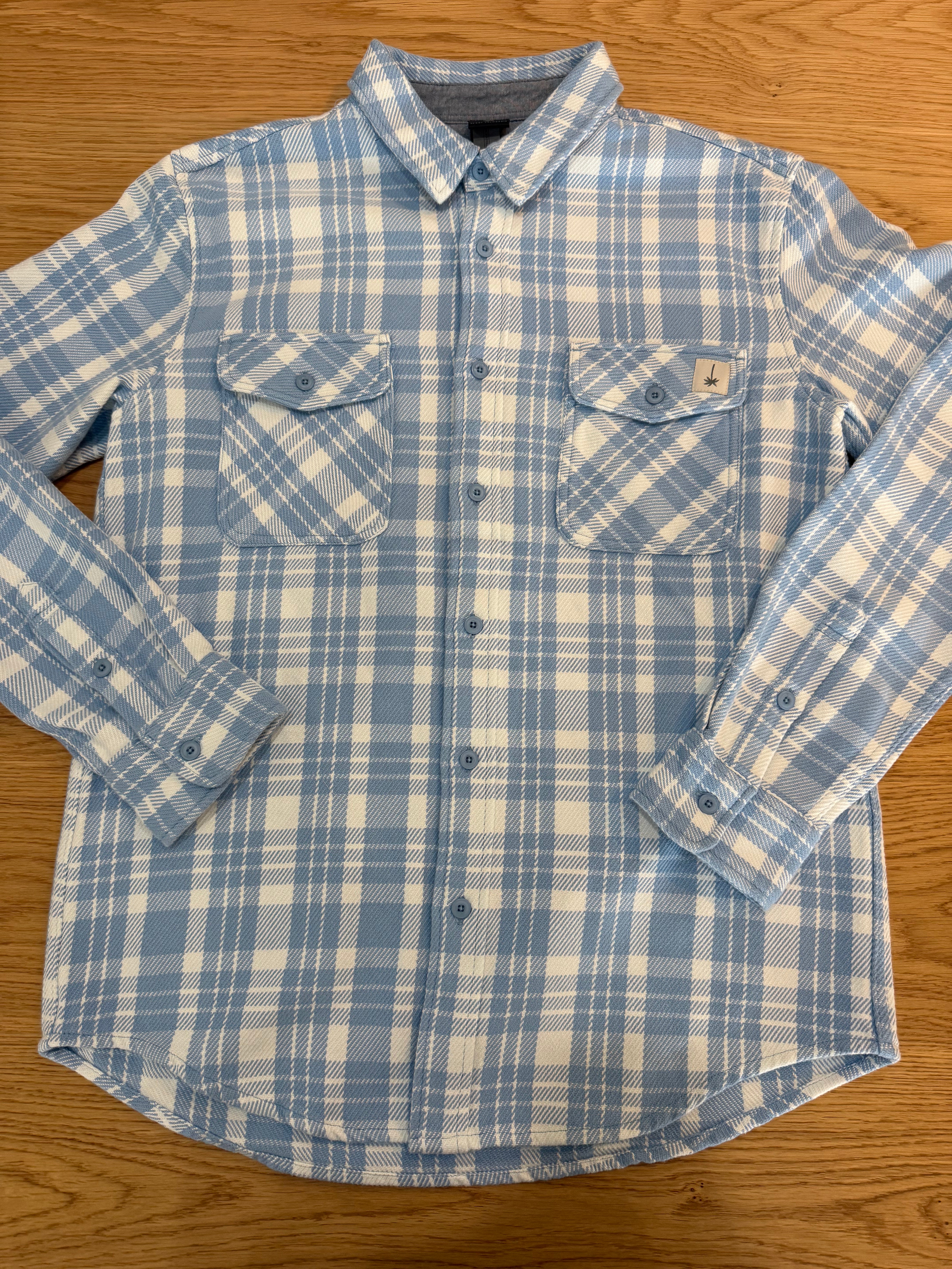 Blue and white plaid shirt on a wooden surface