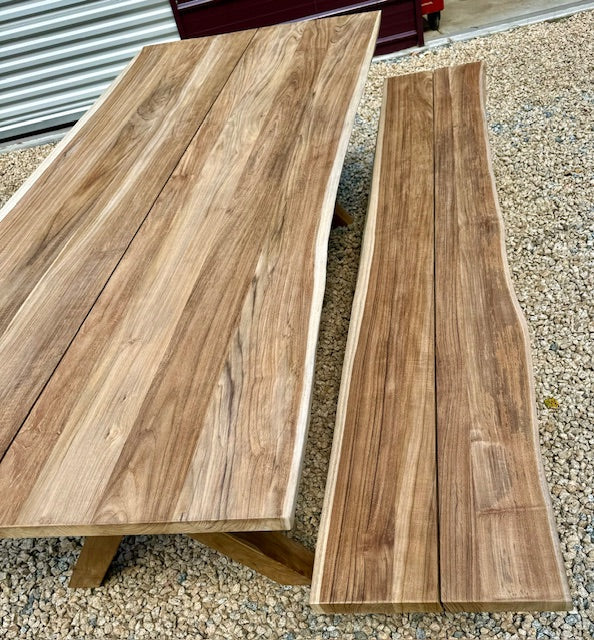 Two wooden slabs on a gravel surface