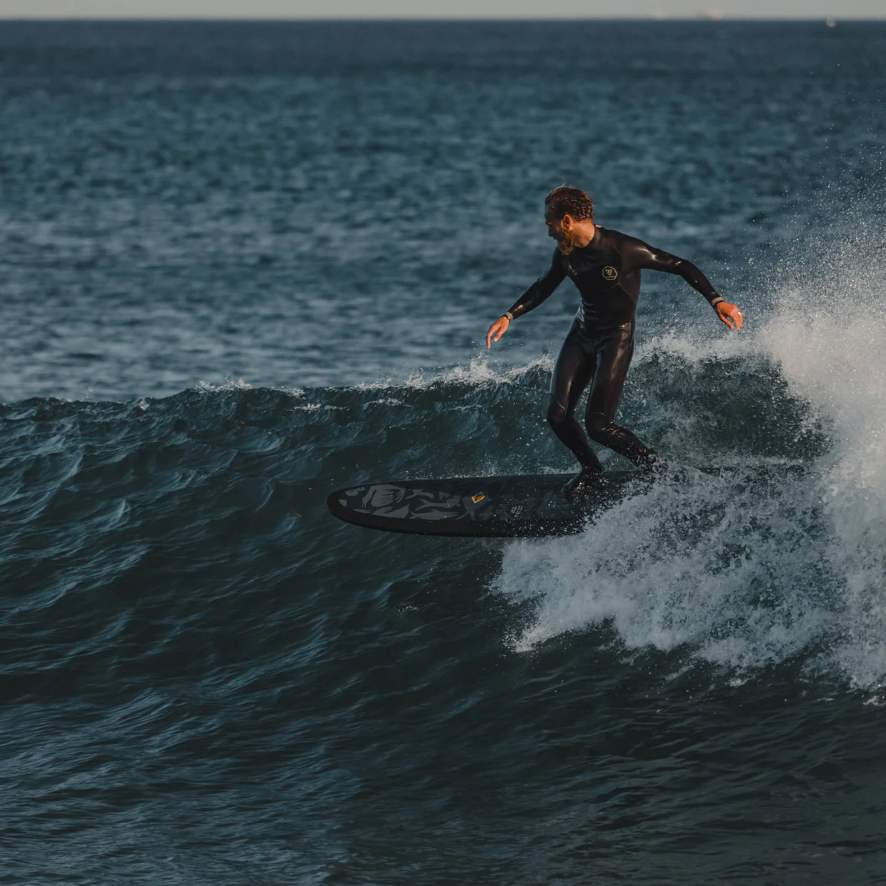 Person surfing on a wave in the ocean