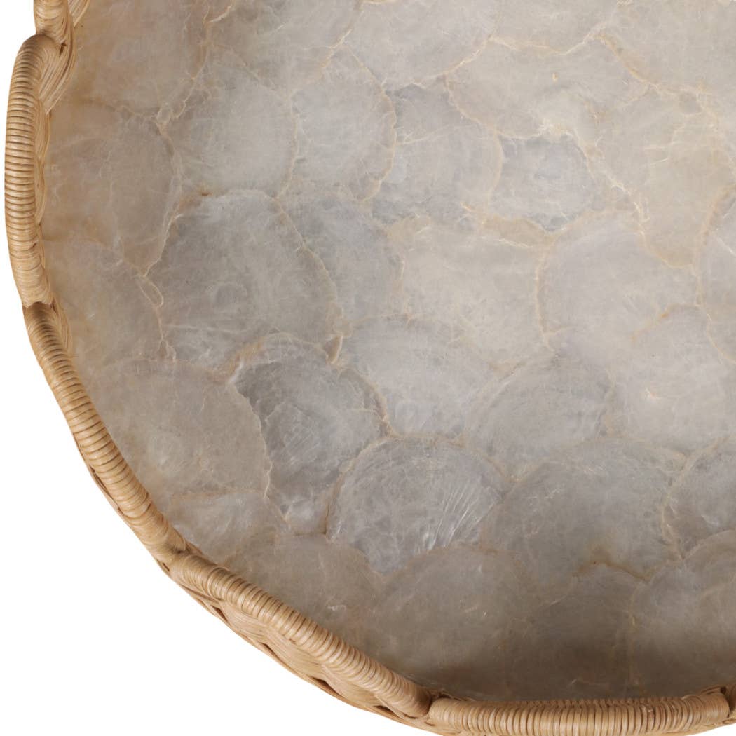 Round stone tray with a woven rim on a white background
