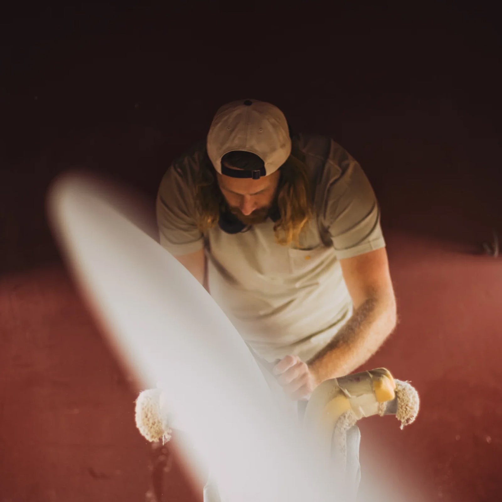 Ryan Lovelace is working on a surfboard in his shaping room