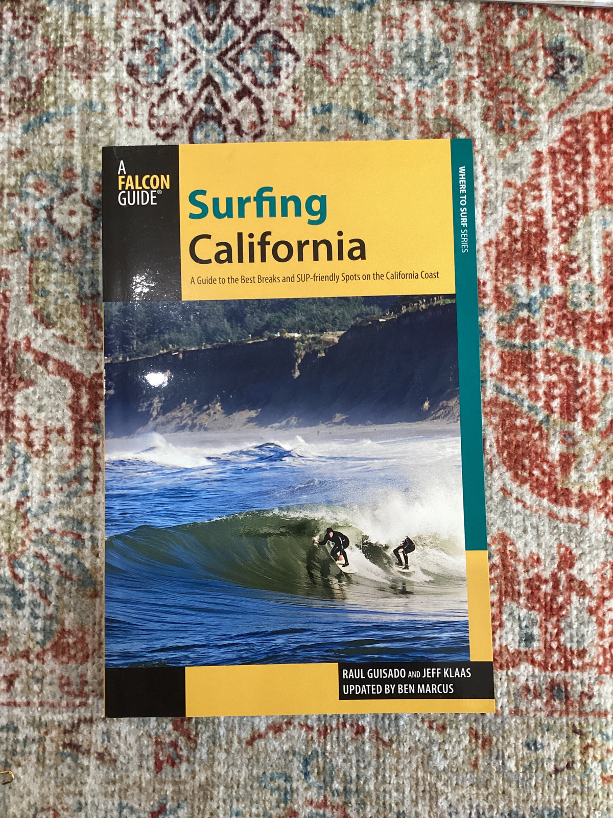 Book titled 'Surfing California' on a patterned rug