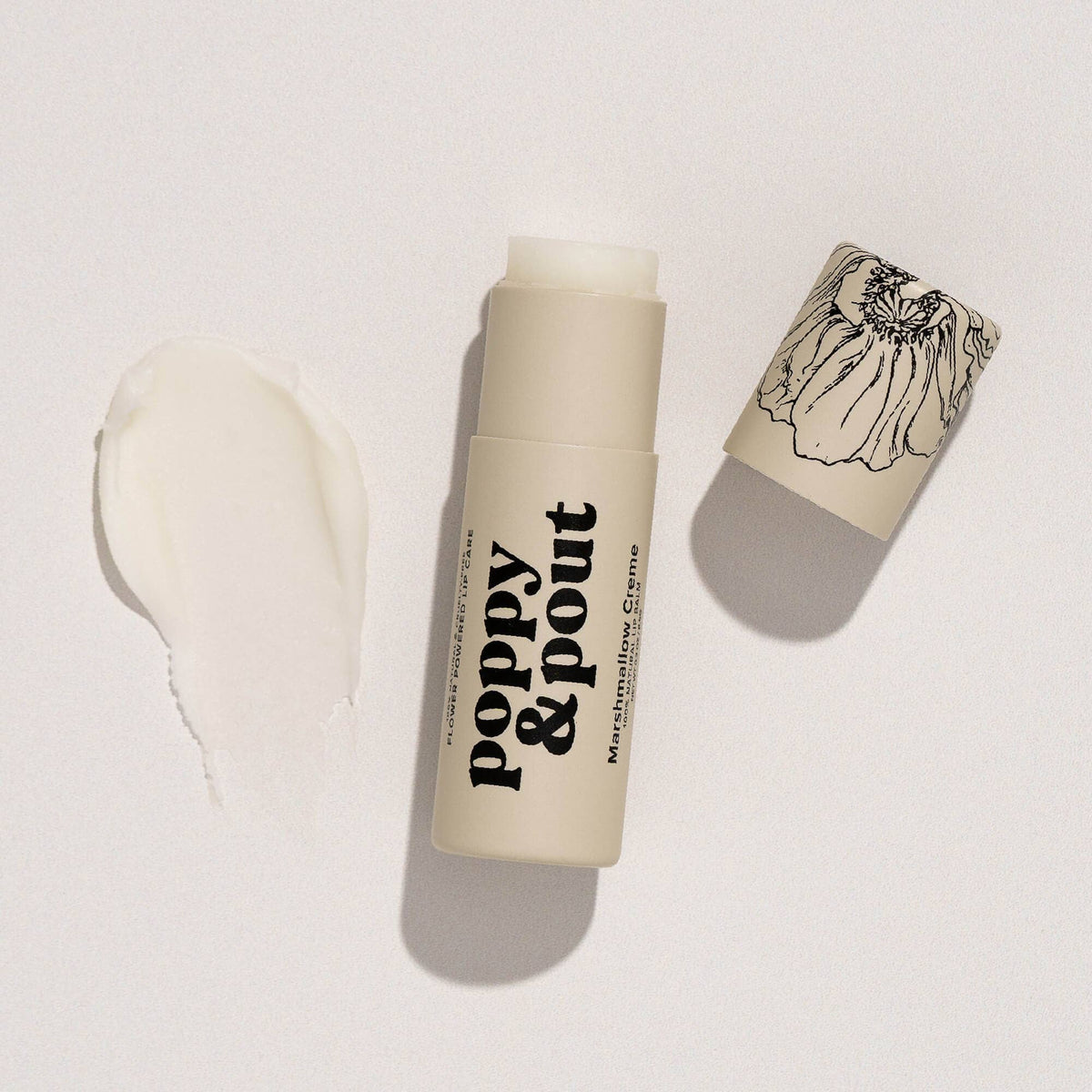 Lip balm with 'Poppy & Pout' branding on a light background