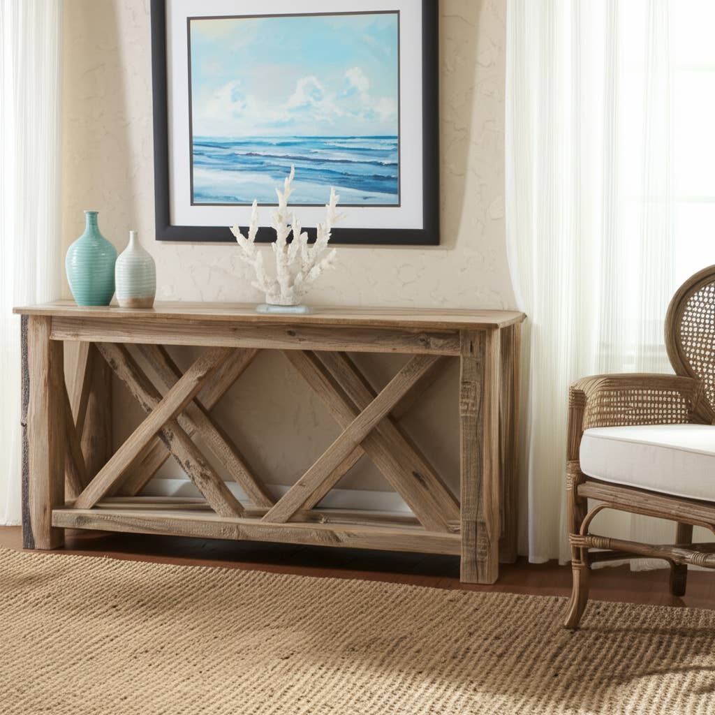 Wooden console table with decorative items in a room with a chair and framed artwork.