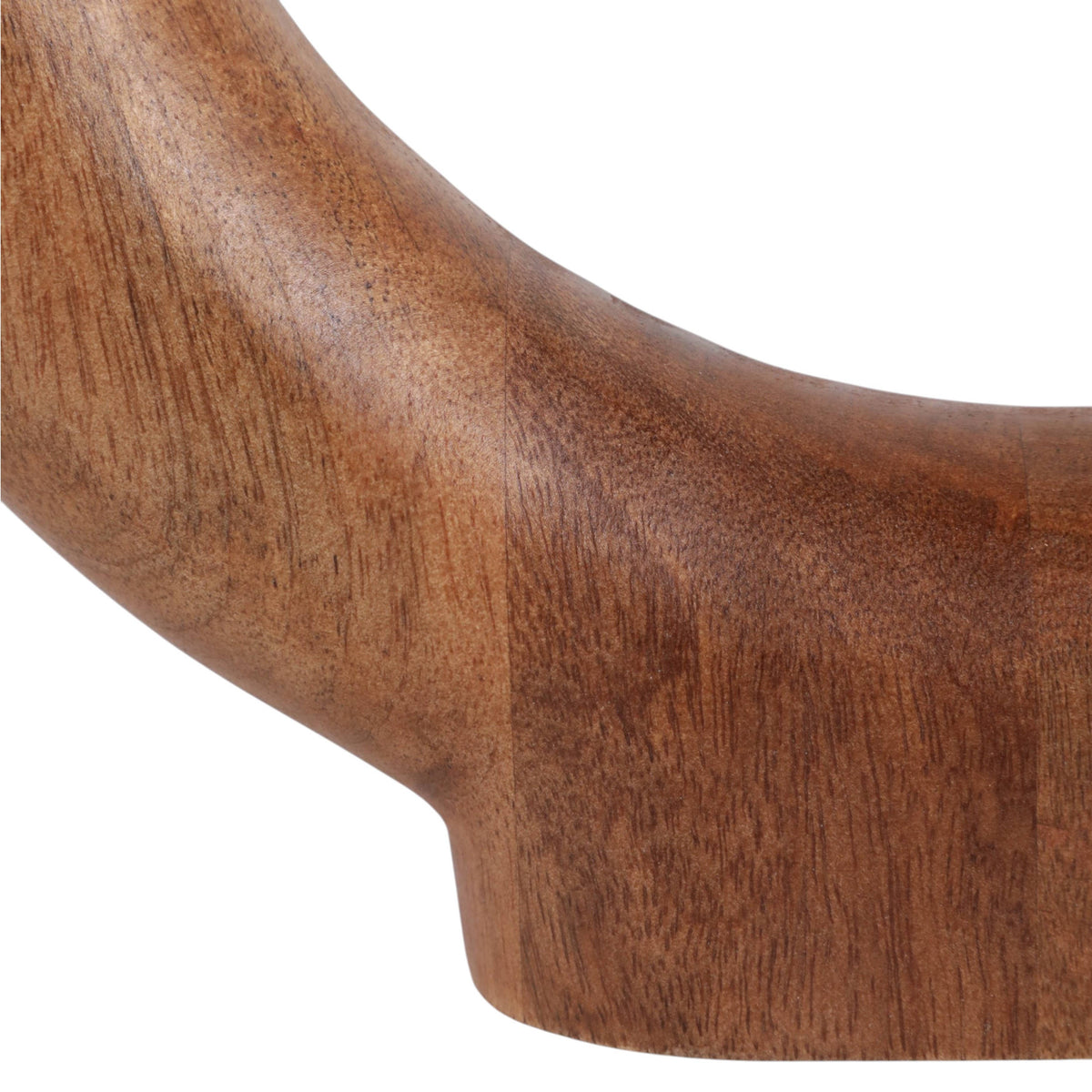 Close-up of a curved wooden object showing a warm medium-brown wood grain texture against a plain white background.