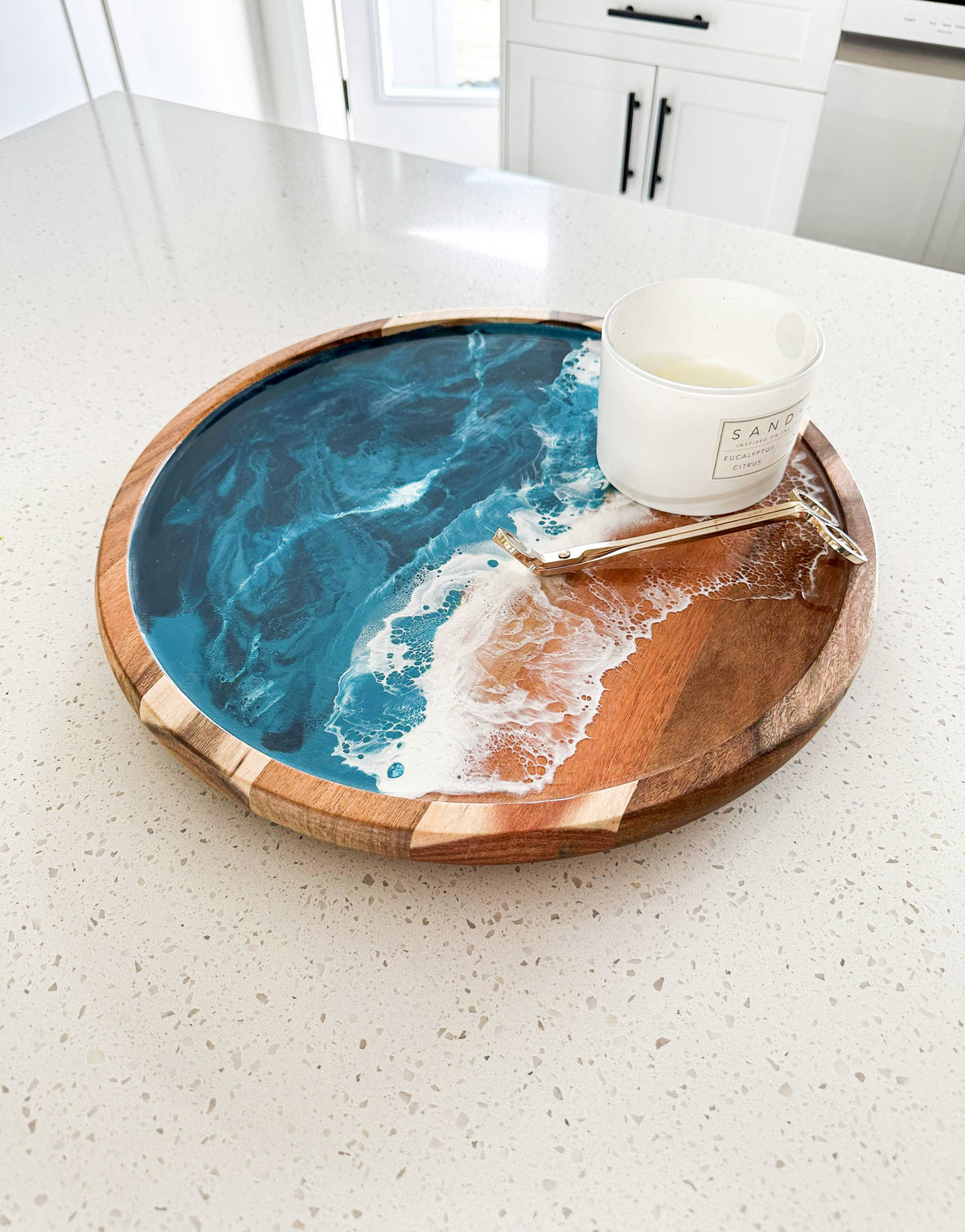 Round wooden tray with blue and white design on a white surface