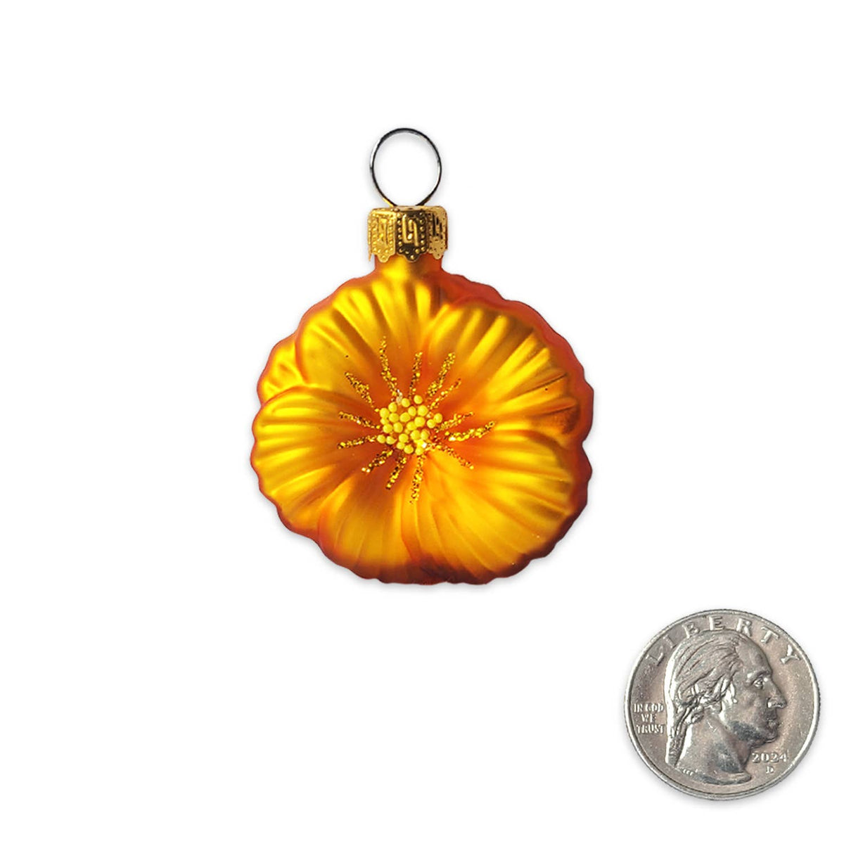 An orange and yellow California Poppy Christmas ornament with a gold cap and silver hanging loop, shown next to a US quarter for scale on a white background.