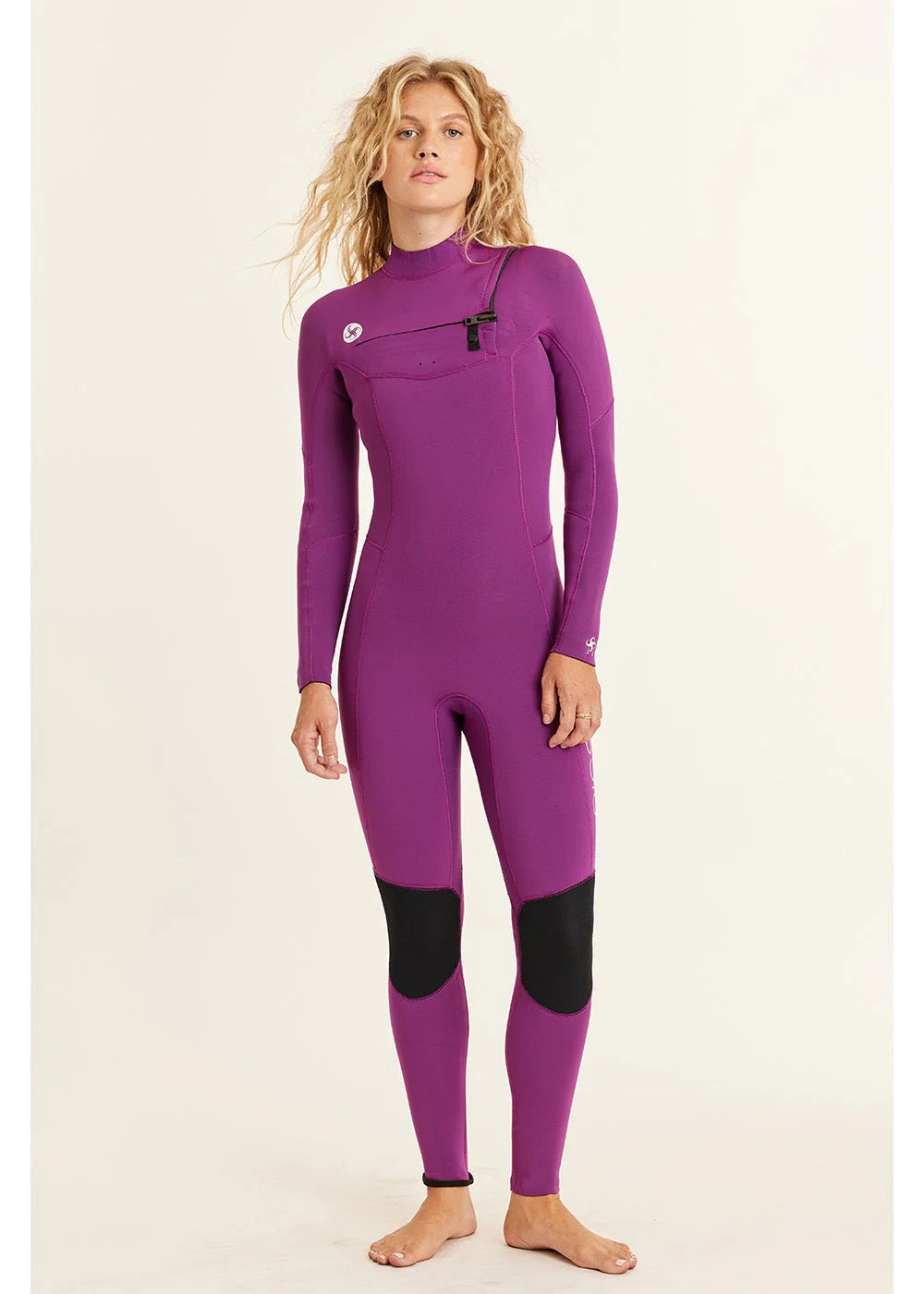 Woman wearing a purple wetsuit on a beige background