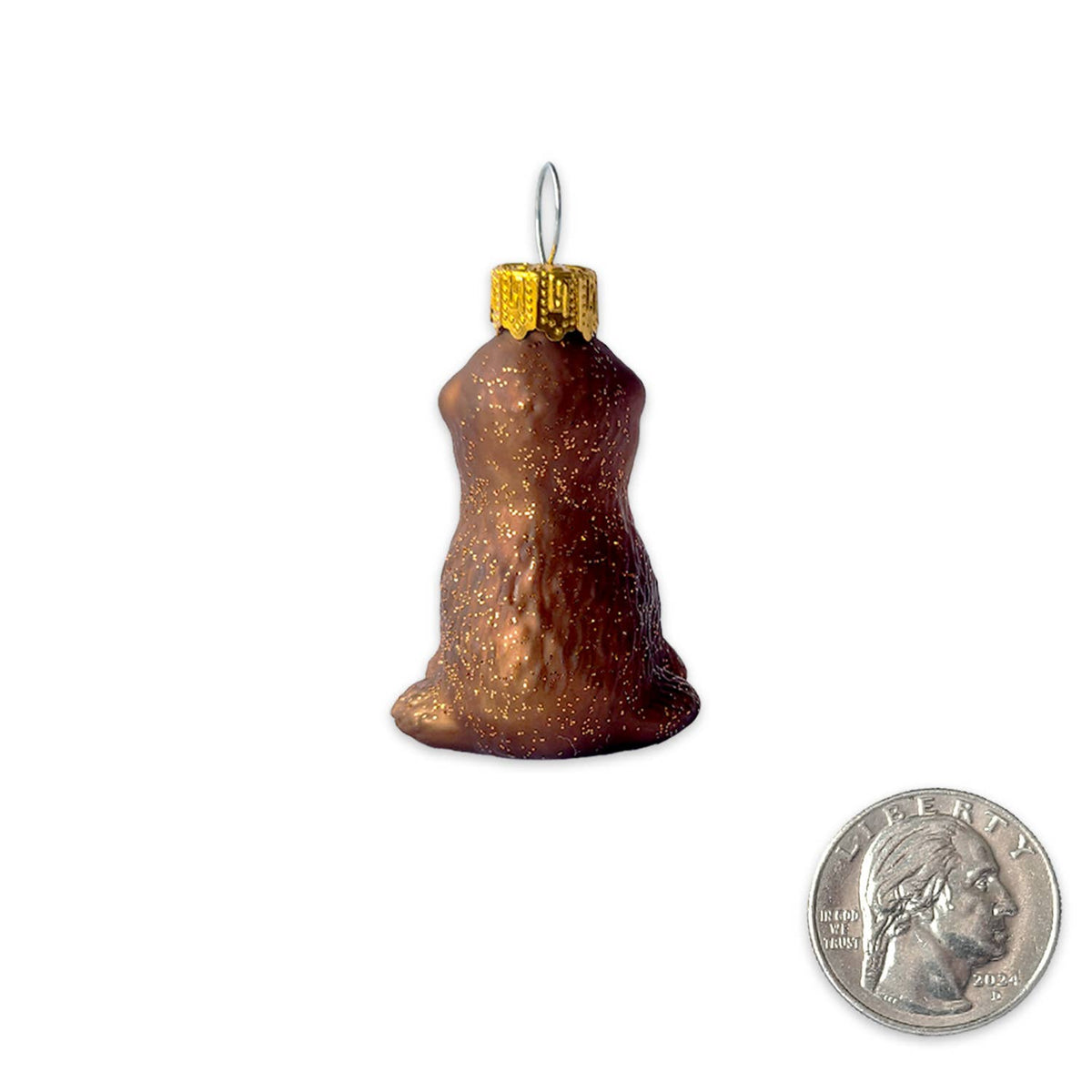 A small brown glitter Christmas ornament shaped like a dog, shown on a white background with a U.S.