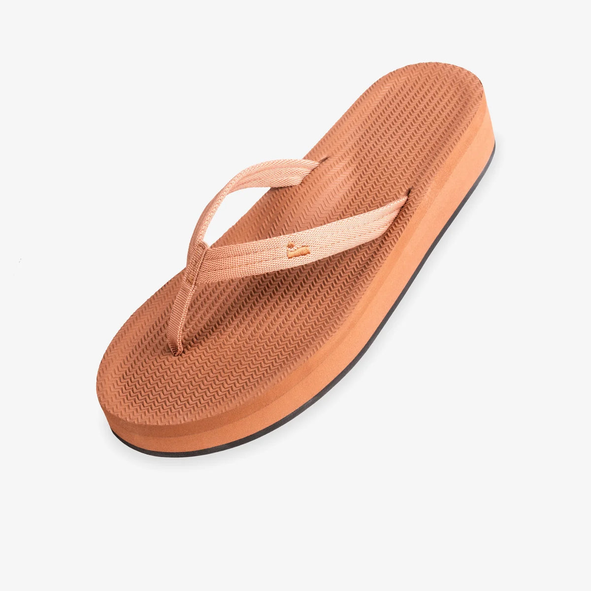 Brown sandal with a white strap on a light gray background