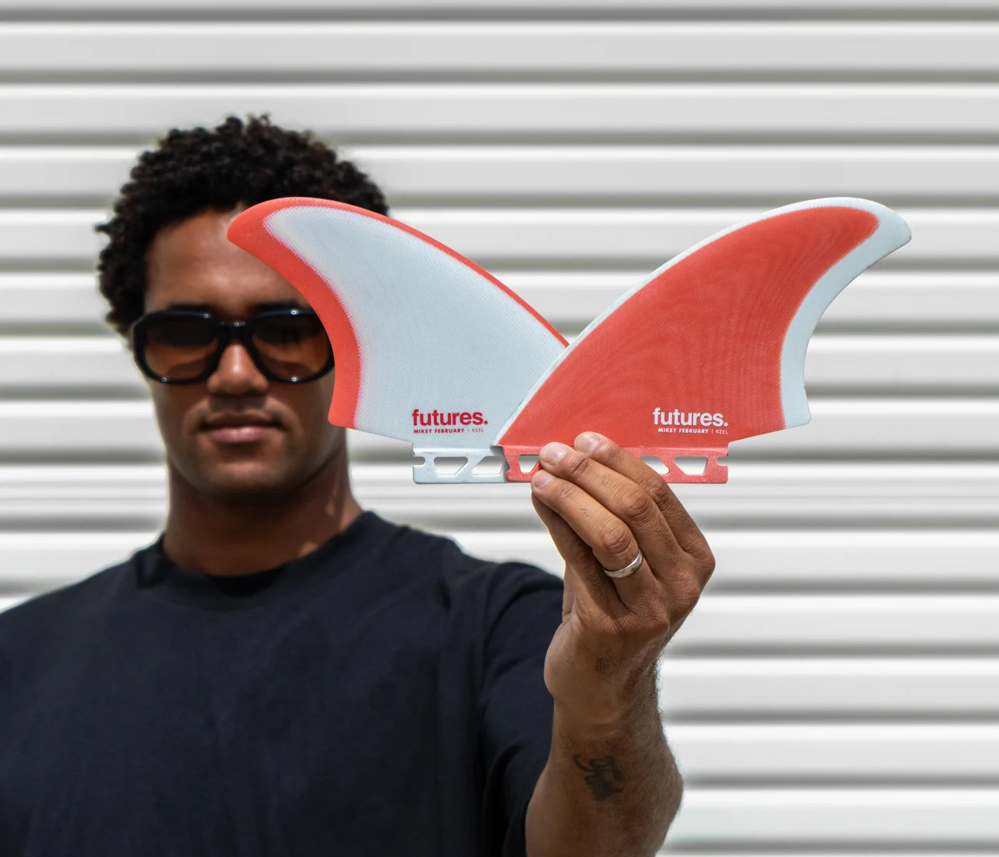 Mikey February holding a Futures Mikey February Fiberglass Keel Fin Set