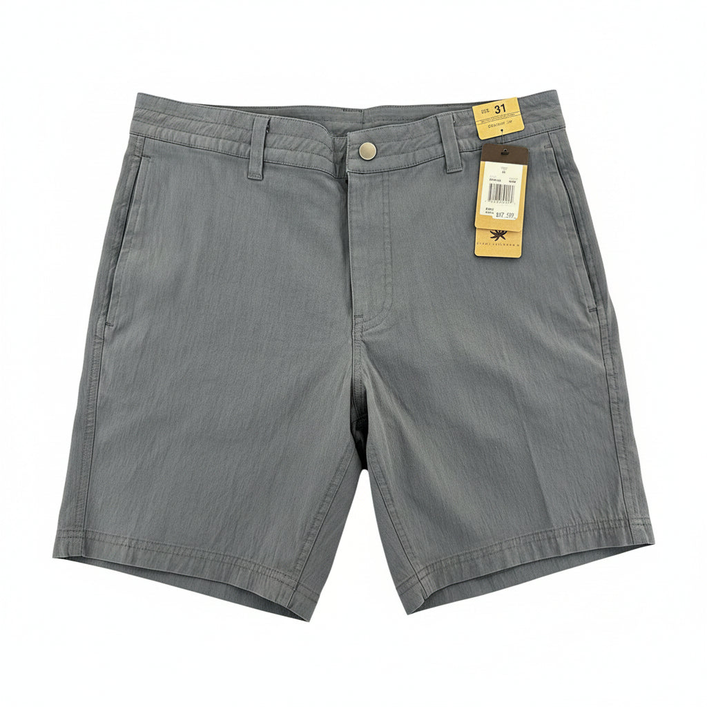A pair of gray chino shorts laid flat on a wooden floor, with a size tag and product tag attached near the waistband.