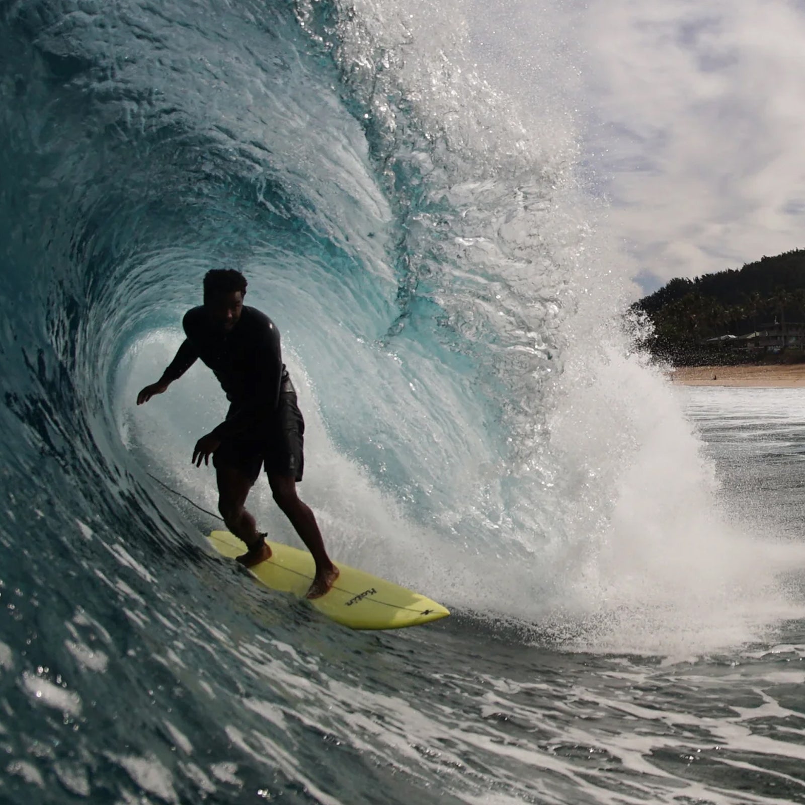 Person surfing on a yellow albumn surfboard
