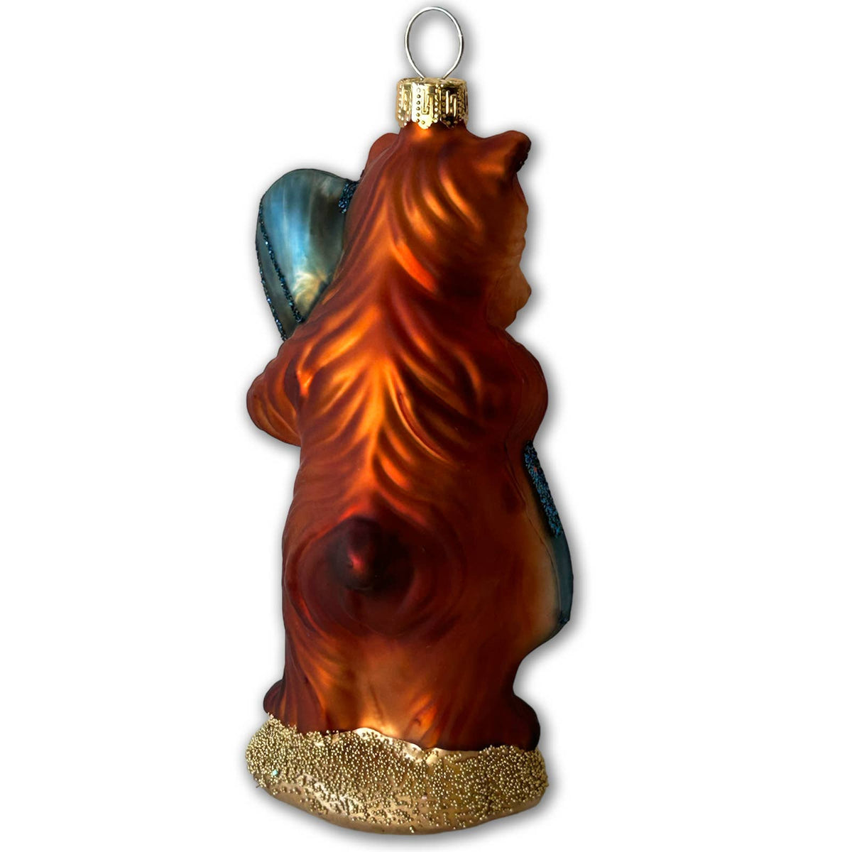 A handcrafted glass Christmas ornament shaped like a bear carrying a blue winged fairy, with a textured gold base and a gold hanging loop at the top.