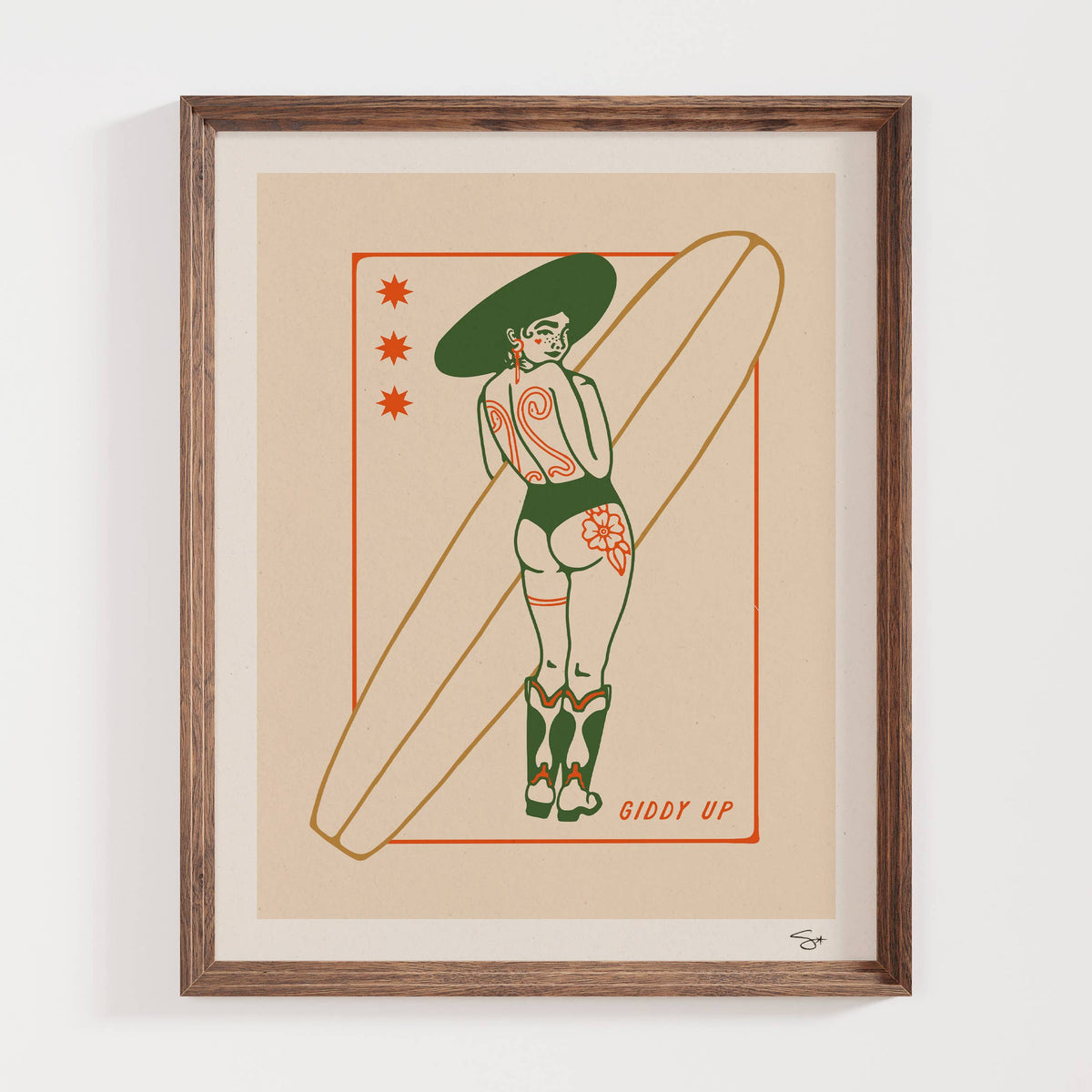 Framed artwork of a woman in a green swimsuit with a surfboard on a beige background