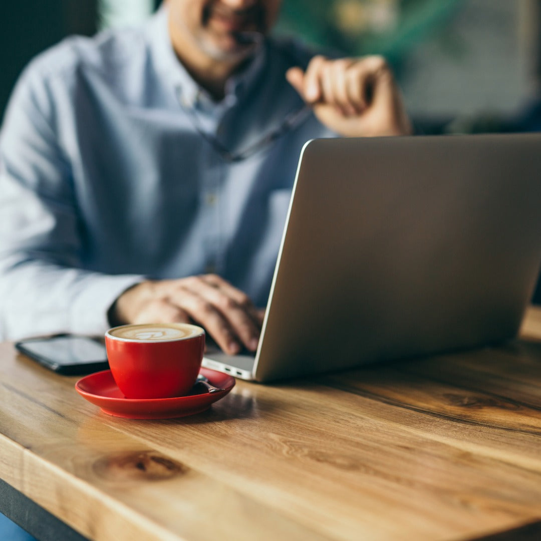 A man working with laptop and coffee