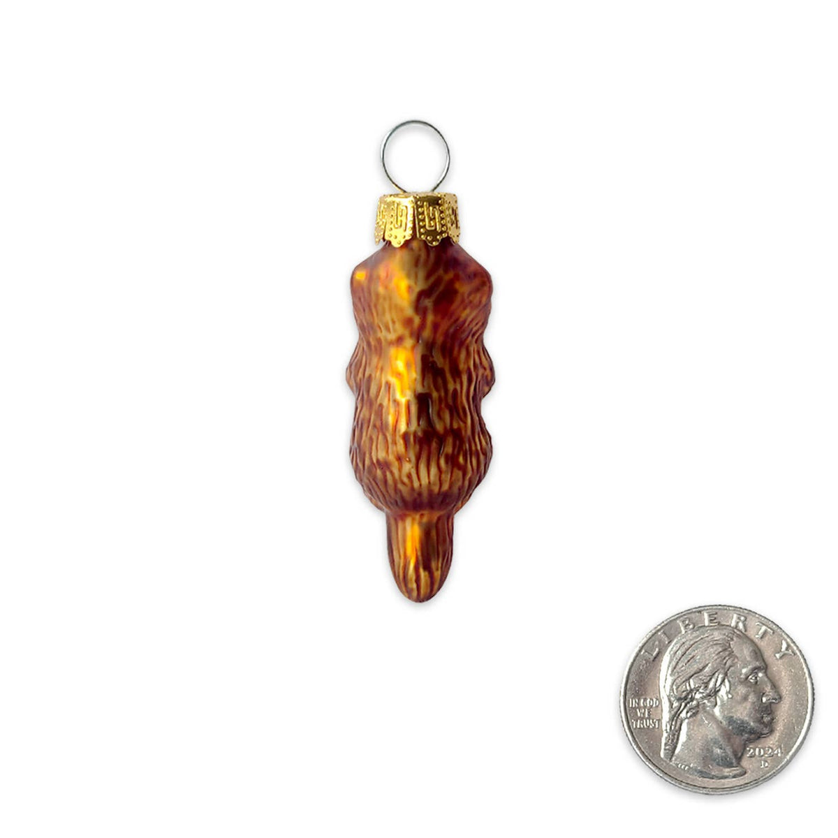 A small amber-brown glass ornament with a gold cap and hanging loop, shown on a white background next to a U.S.