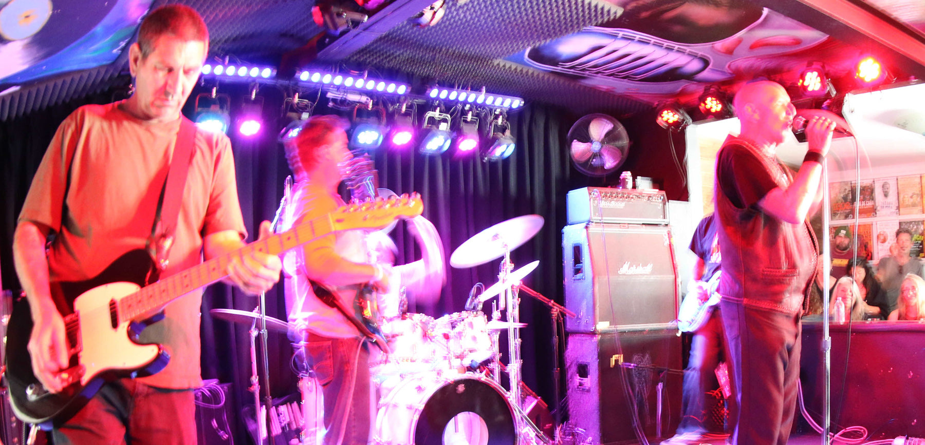 Band performing on stage with musical instruments