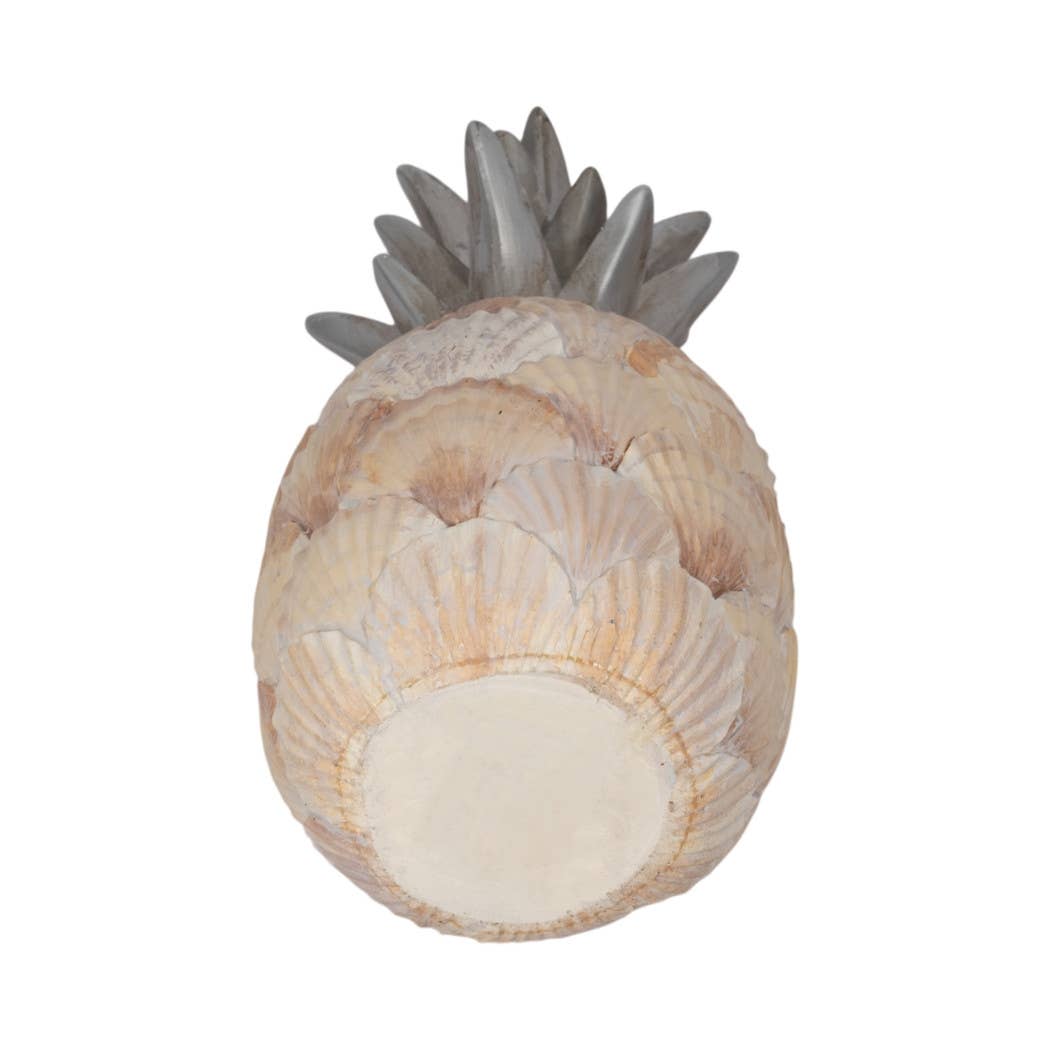 Decorative pineapple made of seashells on a white background