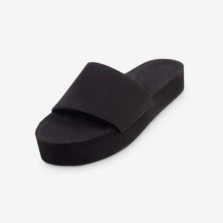 Black slide sandal on a white background